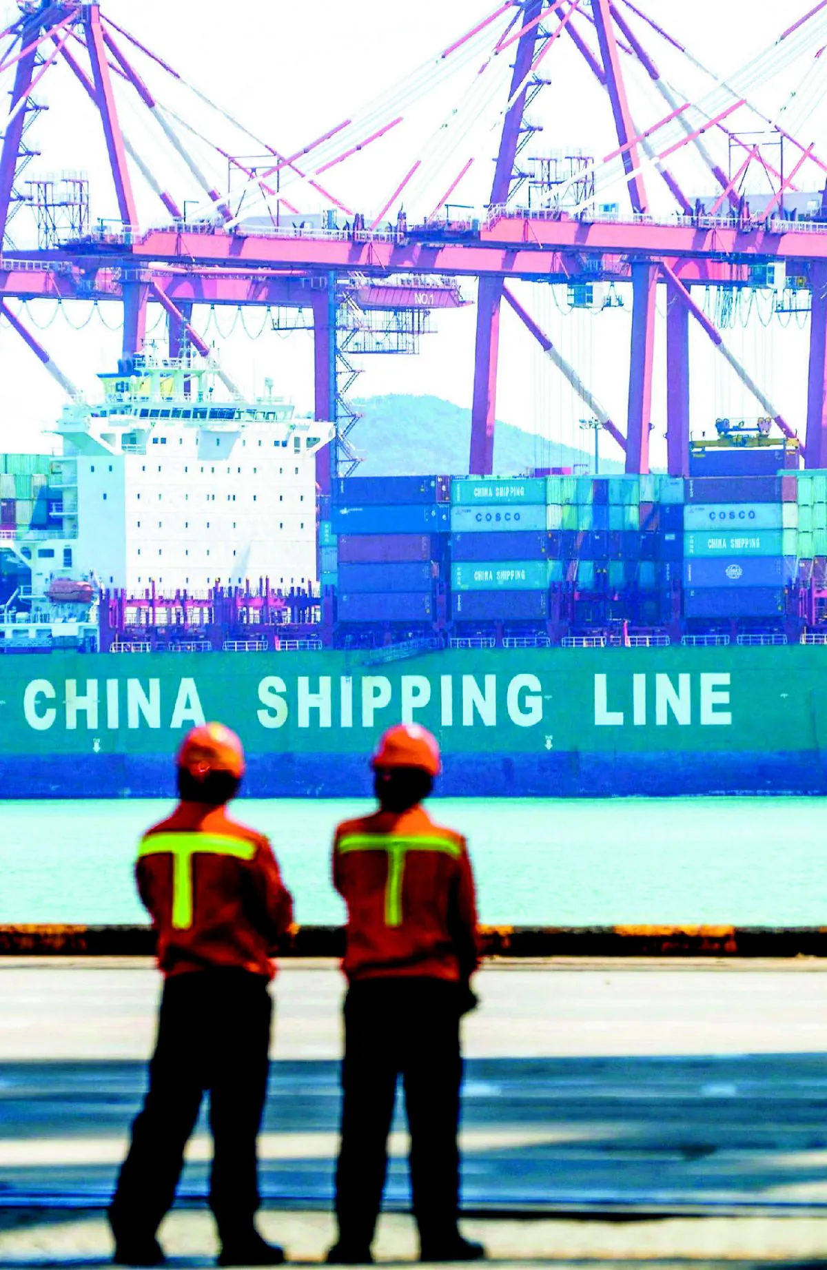 Chinese workers at a pier in Qingdao, China, on April 13. The Belt and Road Initiative is supposed to boost trade both by land and by sea. (STR/AFP/GETTY IMAGES)