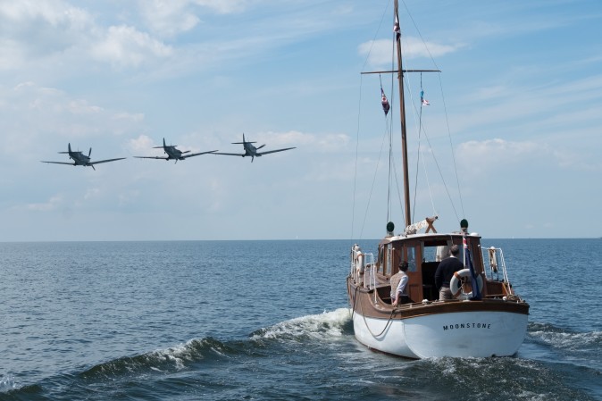 British warplanes and civilian boats to the rescue in a scene from the Warner Bros. Pictures action thriller "Dunkirk,