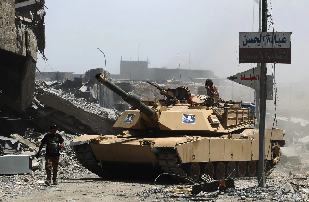 Members of the Iraqi federal police tank is seen in the Old City of Mosul on July 8, 2017, as their part of the battle has been declared accomplished, while other forces continue to fight Islamic State (IS) jihadists in the city. (AHMAD AL-RUBAYE/AFP/Getty Images)