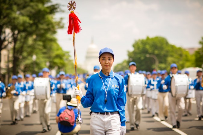 Hundreds of Falun Gong practitioners march in a parade in Washington D.C. on July 20, 2017. The parade is calling for an end to a brutal persecution in China that started on July 20, 1999. (Larry Dye/The Epoch Times)