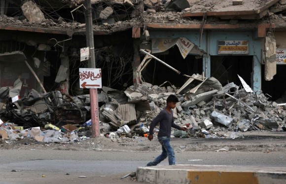 A boy walks along a damaged street in west Mosul on July 13, 2017, a few days after the government's announcement of the "liberation" of the embattled city from Islamic State (IS) group fighters. / AFP PHOTO / SAFIN HAMED (Photo credit should read SAFIN HAMED/AFP/Getty Images)