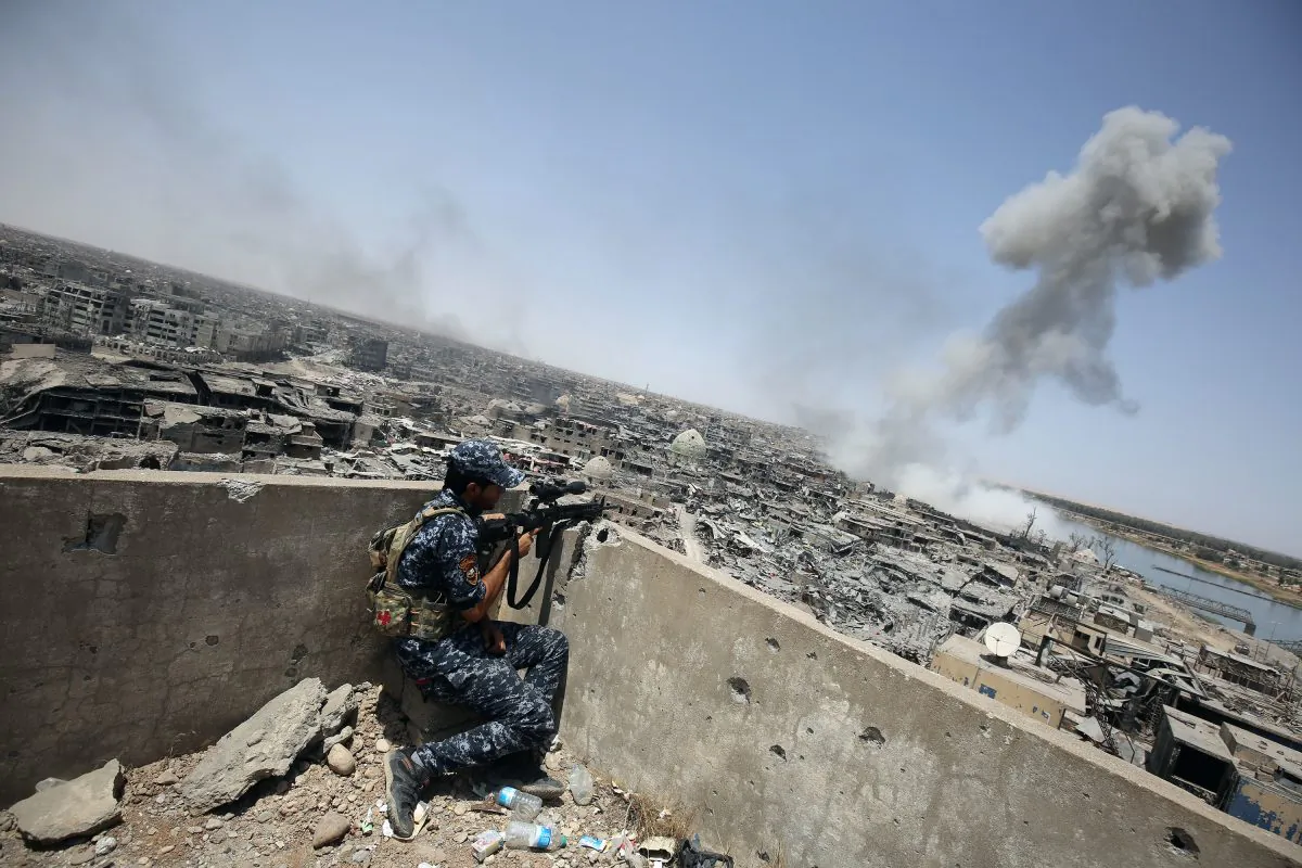 An Iraqi forces sniper looks on as smoke billows, following an airstrike by US-led international coalition forces targeting Islamic State (IS) group, in the Old City of Mosul on July 9, 2017, as their part of the battle has been declared accomplished, while other forces continue to fight Islamic State (IS) jihadists in the city.
(AHMAD AL-RUBAYE/AFP/Getty Images)