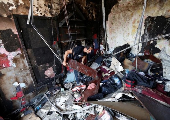 An Afghan shopkeeper inspects his shop after a suicide attack in Kabul, Afghanistan July 24, 2017. (Reuters/Mohammad Ismail)