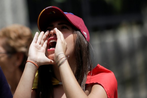An opposition supporter shouts slogans during a rally against the National Constituent Assembly, outside a school where a polling center will be established for a Constitutional Assembly election next Sunday, in Caracas, Venezuela July 24, 2017. (Reuters/Marco Bello)