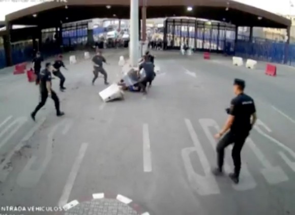 Police officers stop a man on the border at Beni Enzar between Morocco and the Spanish enclave of Melilla, July 24, 2017 in this still image from a CCTV video obtained from social media. (Interior Ministry via Reuters)