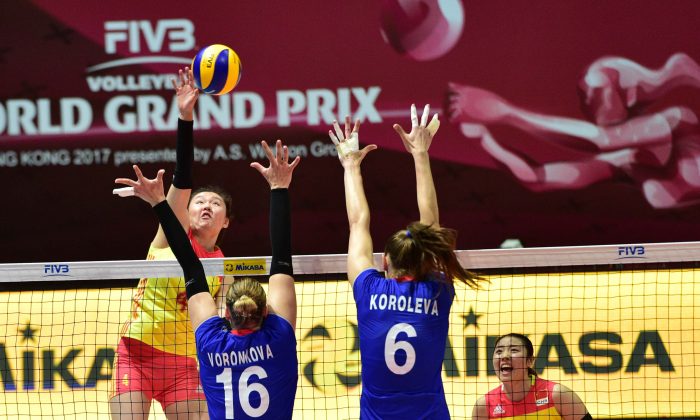 China (red and yellow kit) playing against Russia in the Hong Kong leg of the FIVB Volleyball World Grand Prix on Saturday July 22. Russia won this encounter 3-1. (Bill Cox/Epoch Times)