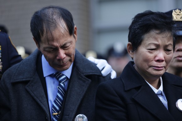 Wei Tang Liu (L), the father of Detective Wenjian Liu, grieves during a plaque dedication ceremony for two fallen New York Police Department officers, Detective Rafael Ramos and his partner Detective Wenjian Liu at the 84th Precinct in Brooklyn on Dec. 20, 2015 in New York City. Detectives Ramos and Liu were fatally shot while sitting in their patrol car in Bedford-Stuyvesant one-year prior. The gunman, Ismaaiyl Brinsley, then killed himself. (Spencer Platt/Getty Images)