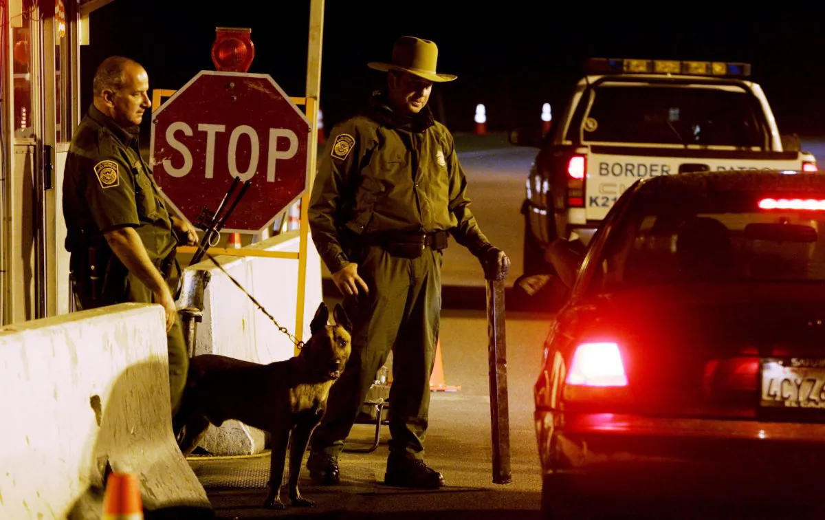 Customs and Border Patrol agents prepare to question a motorist at a checkpoint in Campo, California, in an undated file photo. (Sandy Huffaker/Getty Images)