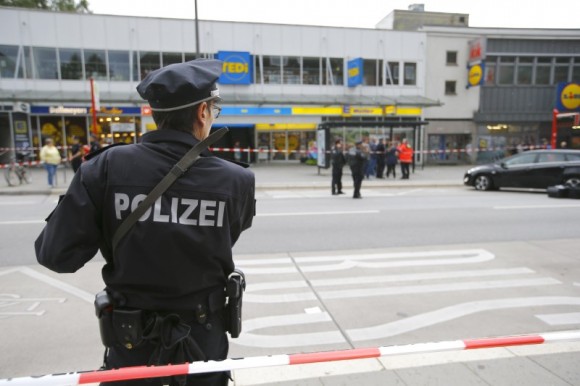 A police officer looks on after a knife attack in a supermarket in Hamburg, Germany, July 28, 2017. (Reuters/Morris Mac Matzen)
