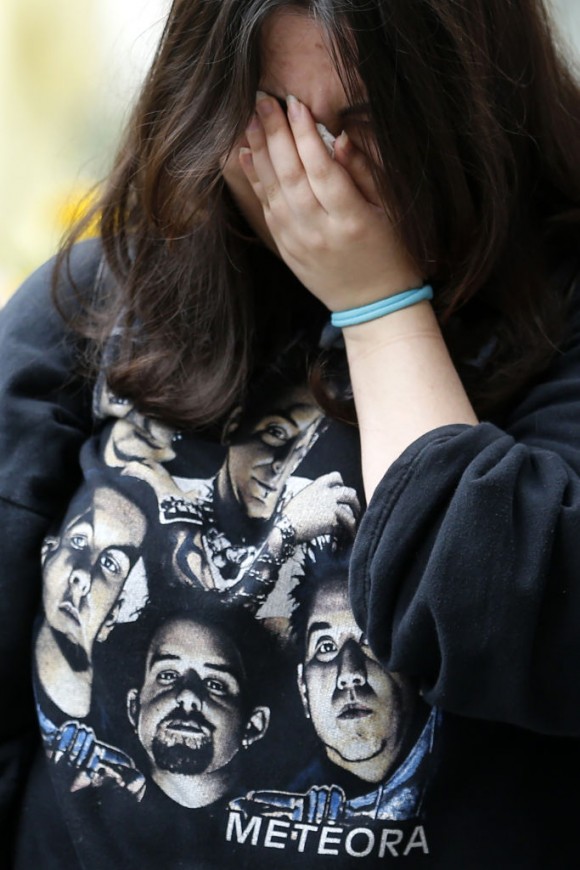 A woman cries as people gather in memory of Linkin Park frontman Chester Bennington in front of the US embassy in central Moscow on July 22, 2017. (MAXIM ZMEYEV/AFP/Getty Images)