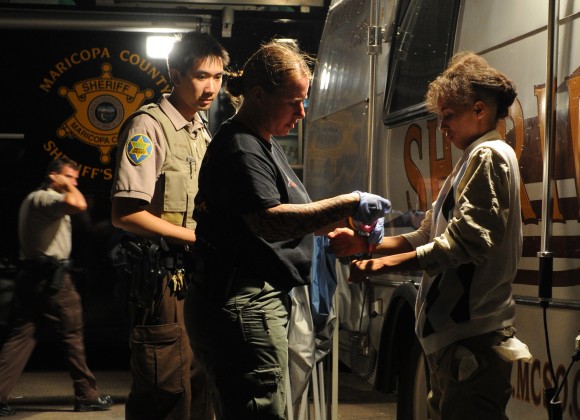An illegal immigrant is processed deputies working for Maricopa County sheriff Joe Arpaio, after an operational sweep in Phoenix on July 29, 2010. (MARK RALSTON/AFP/Getty Images)