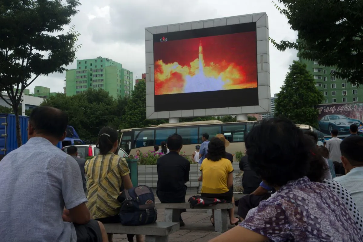 People watch as coverage of an ICBM missile test is displayed on a screen in a public square in Pyongyang on July 29, 2017.
Kim Jong-Un boasted of North Korea's ability to strike any target in the US after a second ICBM test that weapons experts said on July 29 could even bring New York into range. (KIM WON-JIN/AFP/Getty Images)