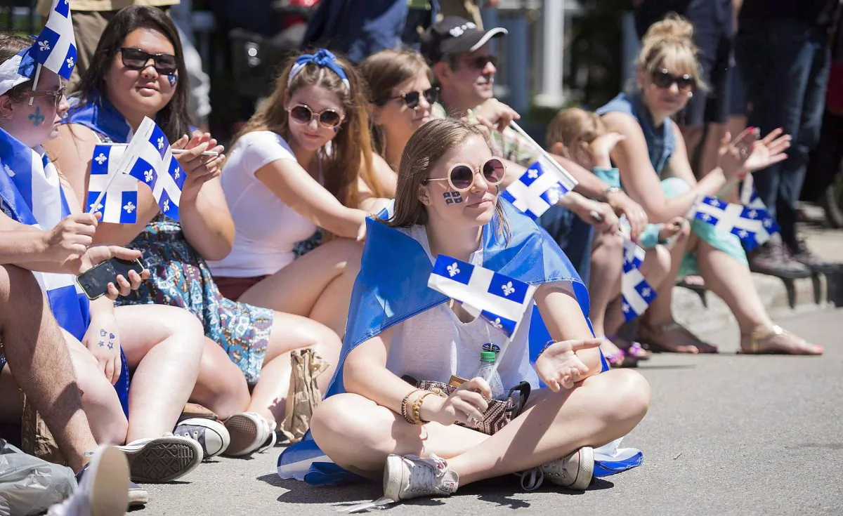 People watch the annual St-Jean-Baptiste Day parade in Montreal on June 24, 2015. Officials are worried the French language is under threat, particularly in Montreal. (CP PHOTO/Paul Chiasson)