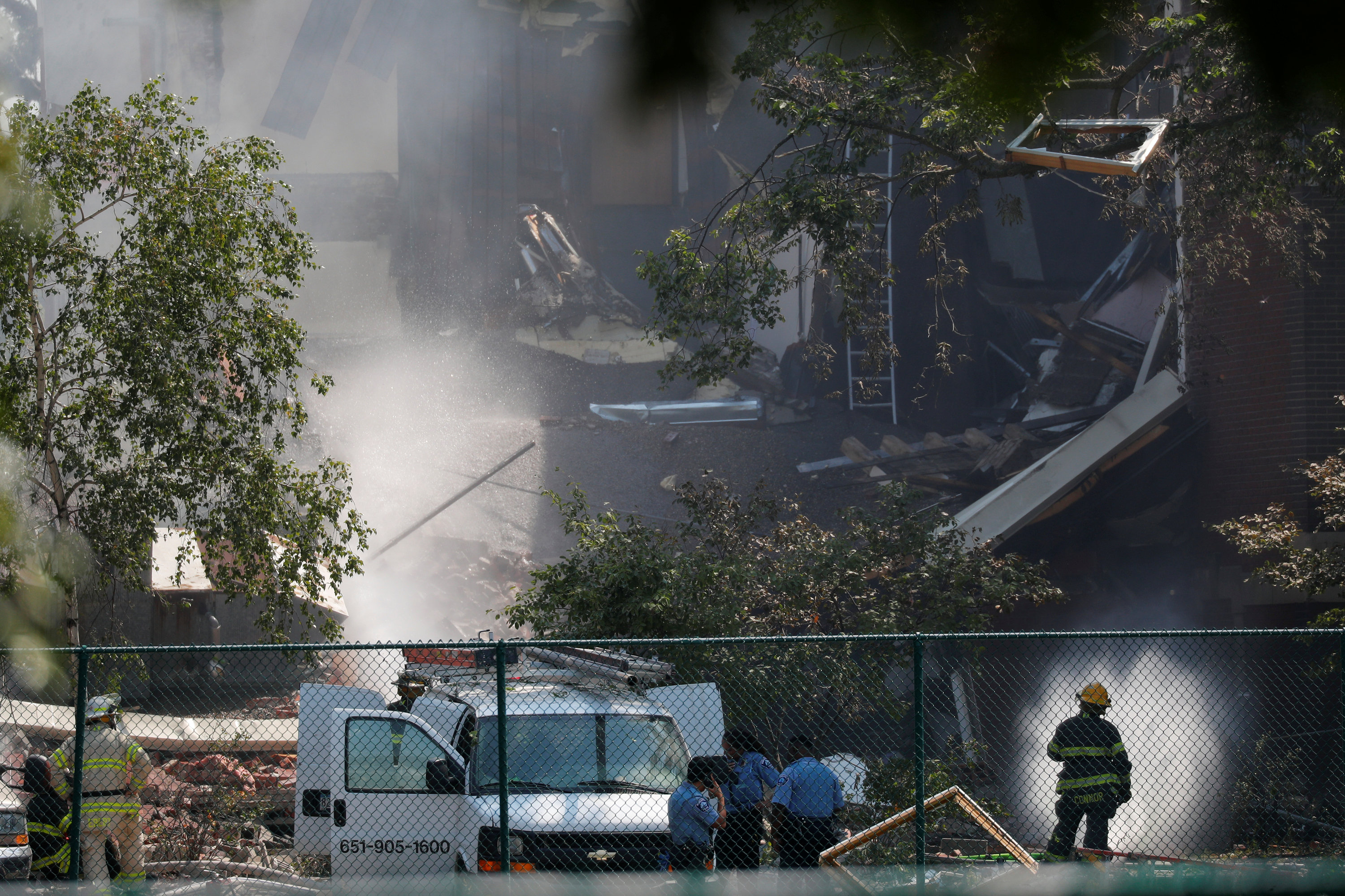 Emergency personnel put water on the scene of school building explosion and collapse at Minnehaha Academy in Minneapolis, Minnesota, U.S., August 2, 2017.  REUTERS/Adam Bettcher