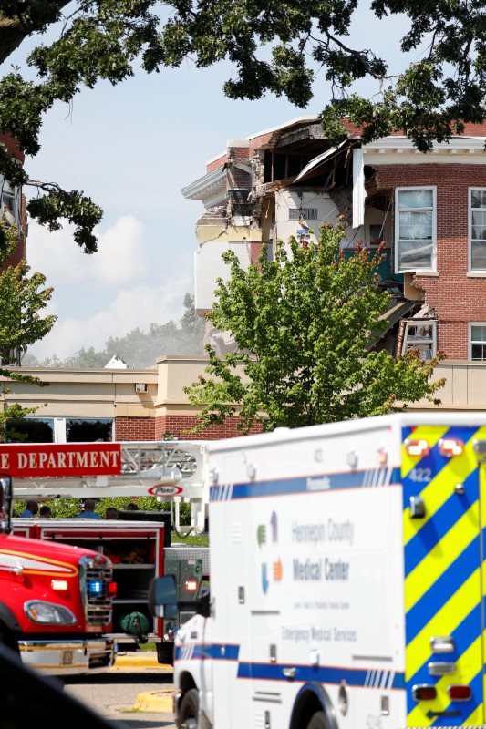 Smoke hangs in the air as emergency personnel work the scene of school building collapse at Minnehaha Academy in Minneapolis, Minnesota, U.S., August 2, 2017.  REUTERS/Adam Bettcher