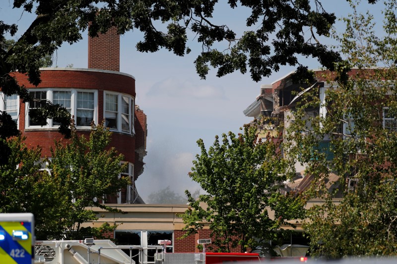 Smoke hangs in the air as emergency personnel work the scene of school building collapse at Minnehaha Academy in Minneapolis, Minnesota, U.S., August 2, 2017.  REUTERS/Adam Bettcher