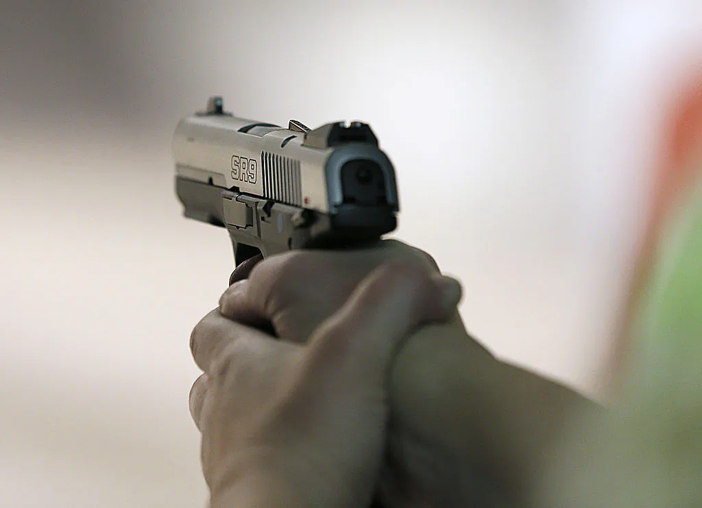 A women fires a handgun. (Photo by George Frey/Getty Images)