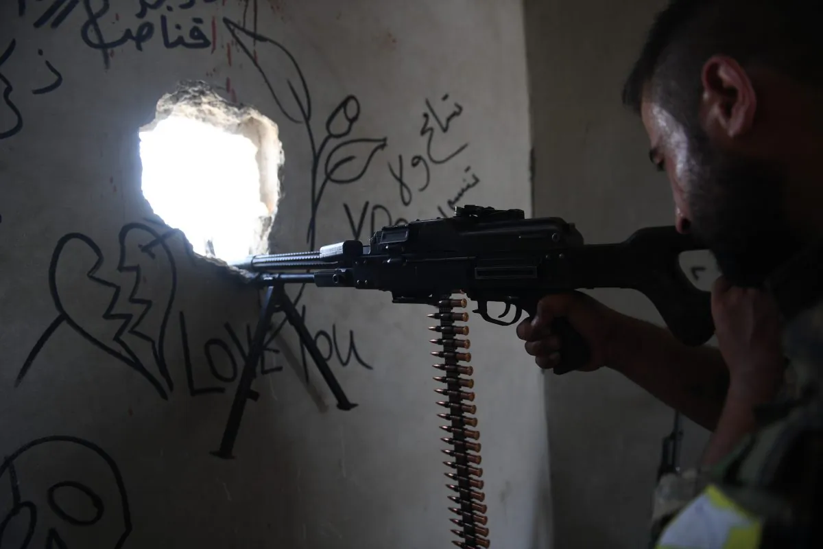 A fighter from the Syriac Military Council (SMC), Christian fighters supporting the Syrian Democratic Forces in the combat against ISIS terrorists, in western Raqa on July 17, 2017. 
(BULENT KILIC/AFP/Getty Images)
