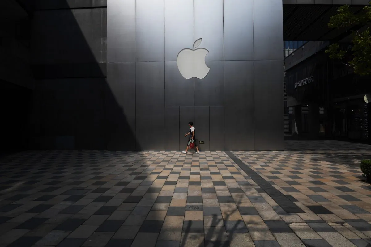 A woman walks past an Apple store in Beijing on August 3, 2017. 
Apple has removed software allowing internet users to skirt China's "Great Firewall" from its app store in the country, the company confirmed, sparking criticism that it was bowing to Beijing's web censorship. (Greg Baker/AFP/Getty Images)