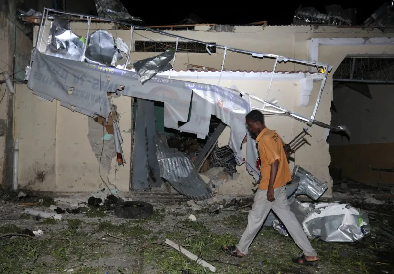 A local security guard walks past the scene after an explosion outside Darishifa hospital in Mogadishu, Somalia on Aug. 4, 2017. (REUTERS/Feisal Omar)