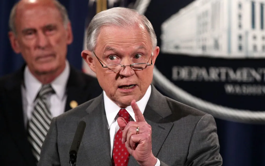 U.S. Attorney General Jeff Sessions (R) speaks as Director of National Intelligence Dan Coats (L) listens during an event at the Justice Department August 4, 2017 in Washington, DC. Sessions held the event to discuss "leaks of classified material threatening national security."  (Photo by Alex Wong/Getty Images)