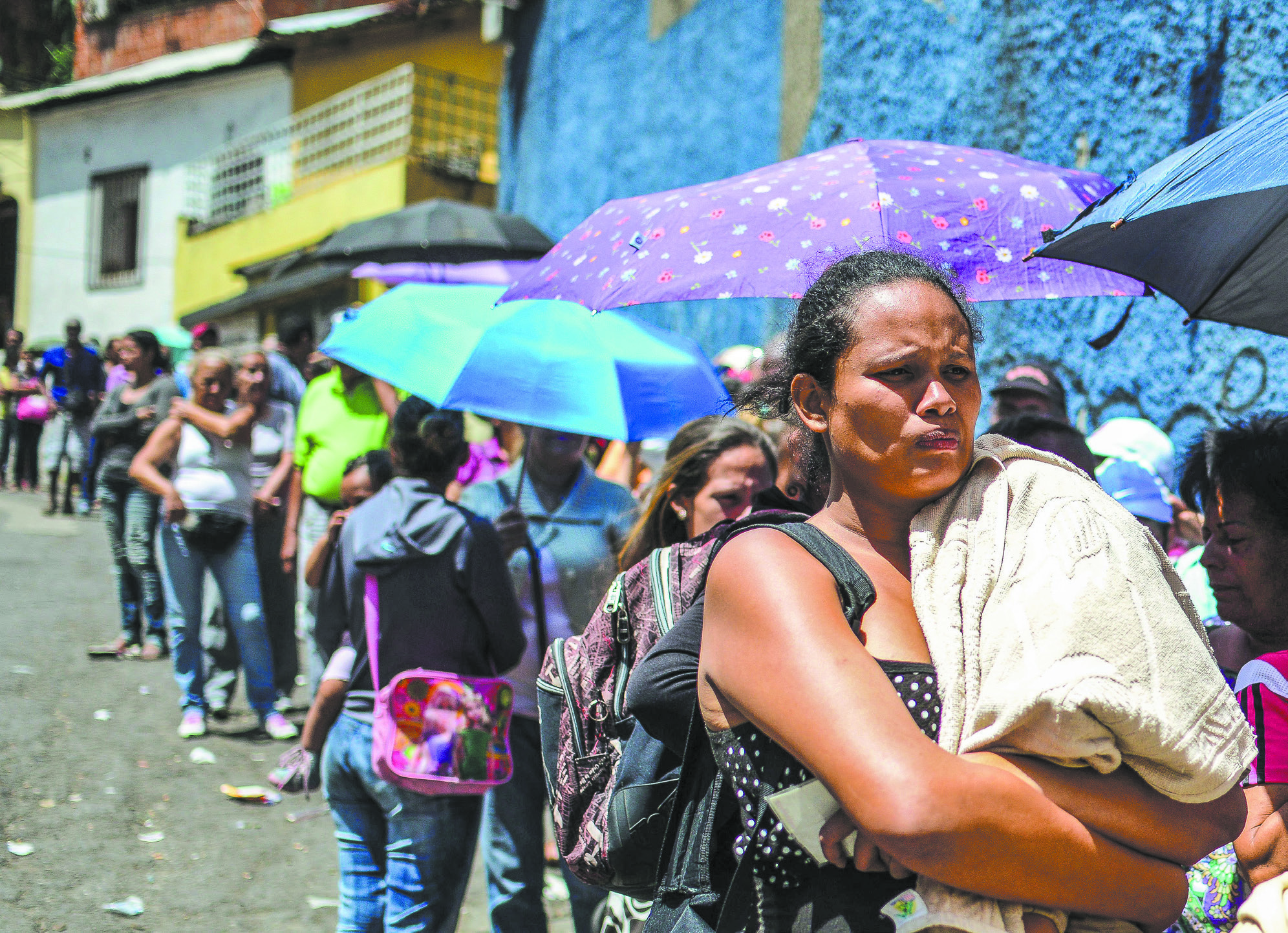 People line up to buy basic food and household items outside a supermarket in Caracas, Venezuela, in 2016. (RONALDO SCHEMIDT/AFP/GETTY IMAGES)