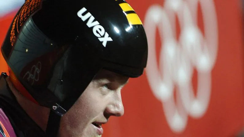 Latvia's Martins Rubenis celebrates after taking bronze in the Men's singles luge final at the Turin 2006 Winter Olympics at Cesana Pariol on Feb. 12, 2006. (ERIC FEFERBERG/AFP/Getty Images)