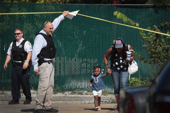 Residents are allowed to leave their home as Chicago Police investigate a murder scene in the Humboldt Park neighborhood on July 27, 2017 in Chicago, Illinois. (Scott Olson/Getty Images)