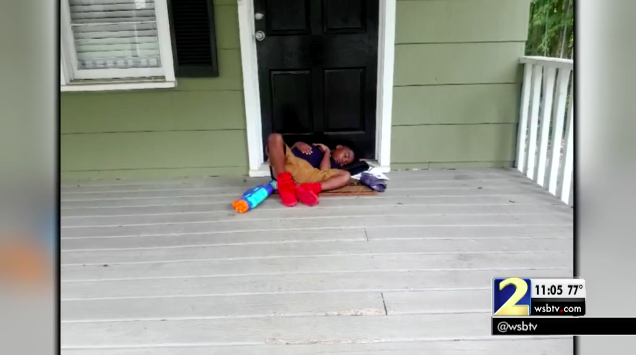 A 9-year-old Georgia boy with special needs sleeping outside his home after a bus driver dropped him off three hours early. (Screenshot via WSB-TV 2)