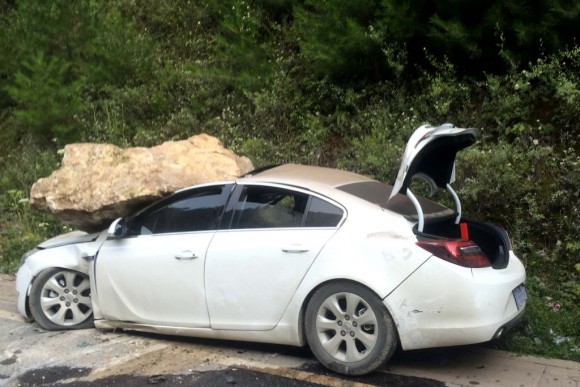 A car, damaged by a rock during an earthquake, is seen in Jiuzhaigou in China's southwestern Sichuan province on August 9, 2017. At least 12 people were killed when a 6.5-magnitude earthquake struck southwestern China, government sources said on August 9, but the toll was expected to climb as news trickles out of the remote mountainous region. / AFP PHOTO / STR / China OUT (Photo credit should read STR/AFP/Getty Images)