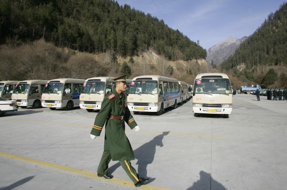 JIUZHAIGOU, CHINA: A Chinese paramilitary soldier inspects parking area at Jiuzhaigou Nine-village valley) in the Aba Tibetan and Qiang Autonomous Prefecture in China's southwestern province of Sichuan, 09 January 2006. The famous attraction tourism Jiuzhaigou Valley is known as the "fairyland on the Earth", was listed by the World Heritage Council of UNESCO into the Catalogue of World Natural Heritage in 1992. AFP PHOTO/ LIU Jin (Photo credit should read LIU JIN/AFP/Getty Images)