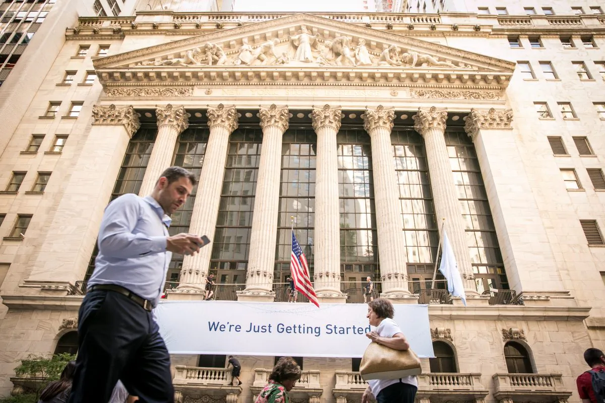 People walk by the New York Stock Exchange in the Financial District of Manhattan on June 26, 2017. (Benjamin Chasteen/The Epoch Times)