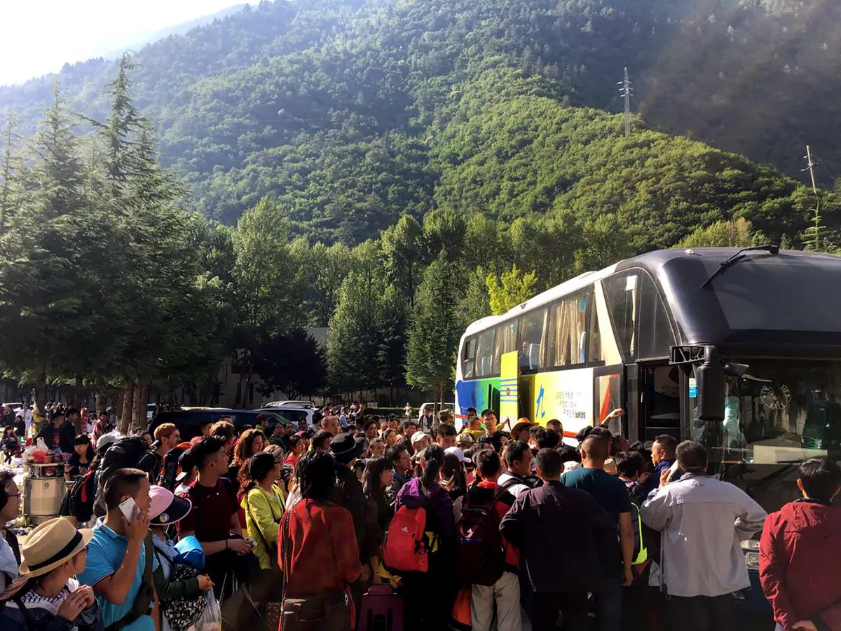 Tourists wait to be evacuated after an earthquake in Jiuzhaigou in China's southwestern Sichuan province on August 9, 2017.
China on August 9 evacuated tens of thousands people in its mountainous southwest after a strong earthquake killed at least 19 people and rattled a region where memories of a 2008 seismic disaster remain fresh. / AFP PHOTO / STR / China OUT (Photo credit should read STR/AFP/Getty Images)