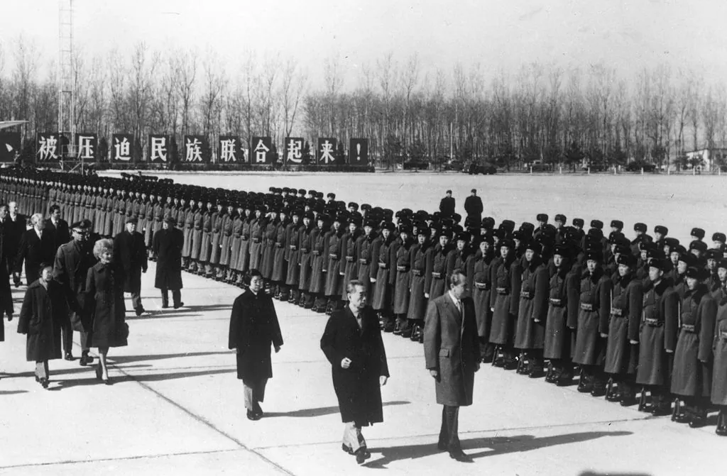 U.S. President Richard Nixon inspecting a guard of honor at Peking (Beijing) airport with Chinese Premier Zhou Enlai, in China, on Feb. 21, 1972. (Keystone/Getty Images)