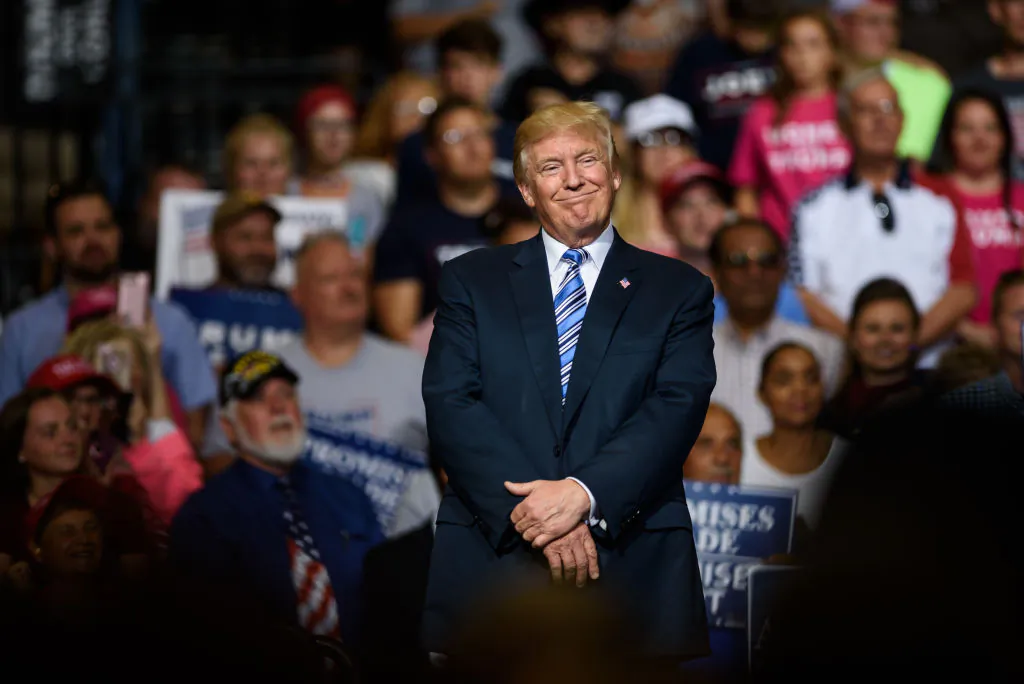 President Donald J. Trump listens as West Virginia Governor Jim Justice announces that he is switching parties to become a republican during the president's campaign rally at the Big Sandy Superstore Arena on August 3, 2017 in Huntington, West Virginia. (Photo by Justin Merriman/Getty Images)