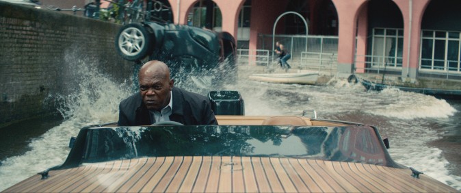 Darius Kincaid (Samuel L. Jackson) piloting a speedboat down a dutch canal, in 