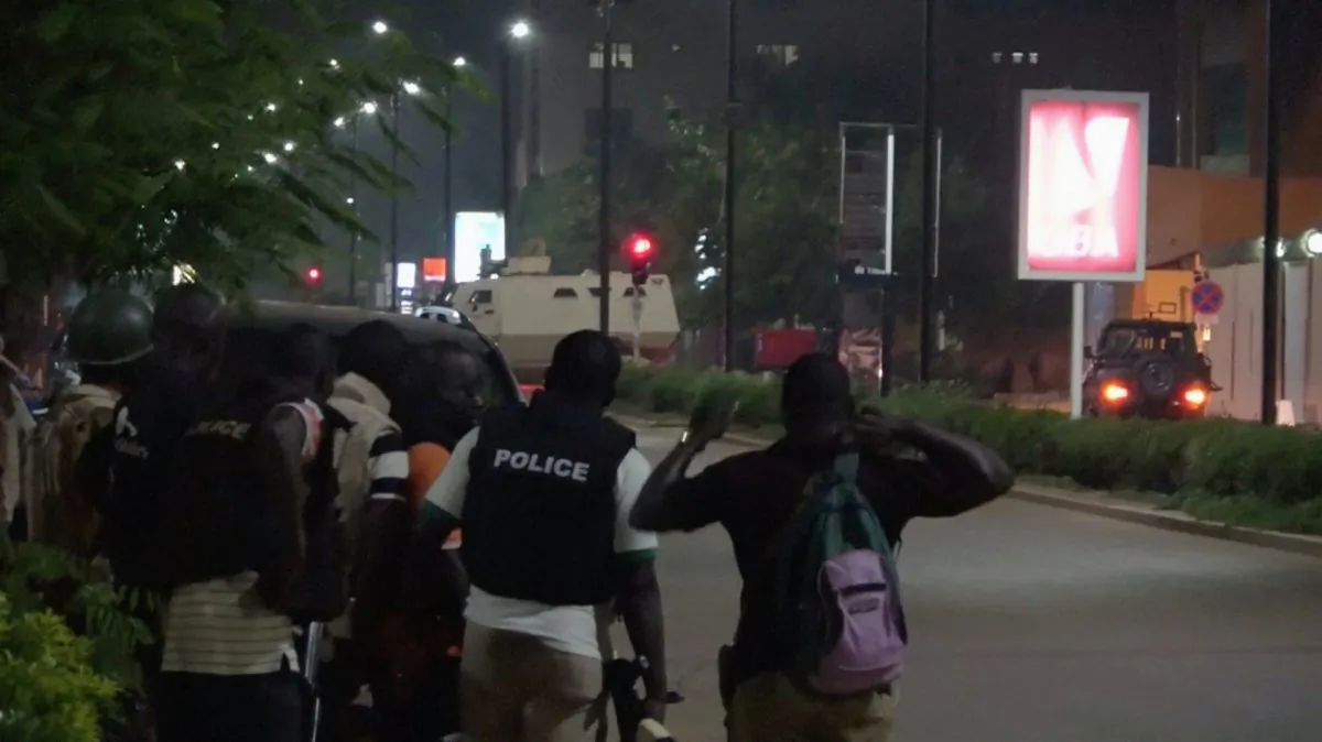 Police are seen on a street following an attack by gunmen on a restaurant in Ouagadougou, Burkina Faso, in this still frame taken from video on Aug. 13, 2017. (REUTERS/Reuters TV)