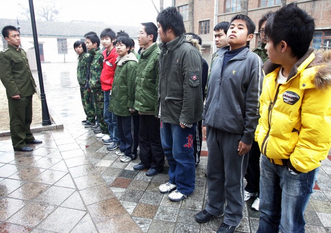 Some 20-odd teenagers assemble at the Internet Addiction Treatment Centre in the southeastern suburb of Daxing in Beijing, 01 March 2007, all placed there involuntarily by their family, to go through a strict regimen that might as well be boot camp. (AFP/AFP/Getty Images)