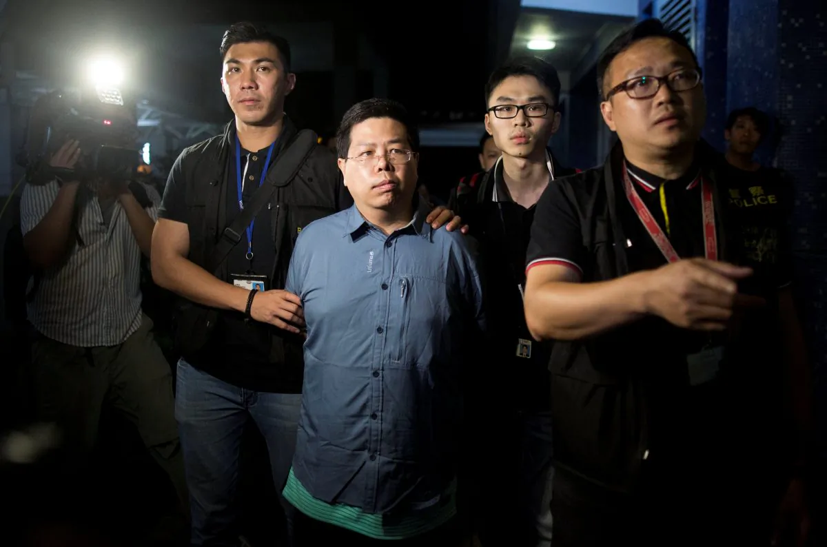 Police arrests Democratic Party member Howard Lam (C) for "misleading police" after he claimed he had been assaulted and illegally detained by mainland Chinese agents, in Hong Kong, China, China August 15, 2017. (The Initium/Lam Chun Tung via Reuters)