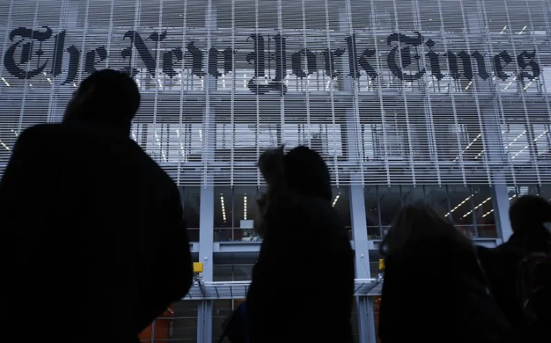 People line up for a taxi across the street from the New York Times head office in New York on Feb. 7, 2013. (REUTERS/Carlo Allegri)