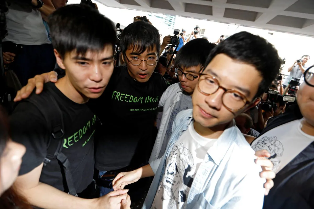 Student leaders Lester Shum, Alex Chow, Joshua Wong and Nathan Law hold hands as they walk into the High Court to face verdict on charges relating to the 2014 pro-democracy Umbrella Movement, also known as Occupy Central protests, in Hong Kong, China on August 17, 2017. (REUTERS/Tyrone Siu)