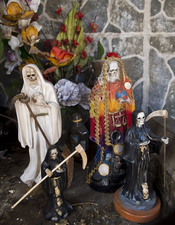 Images of the "San La Muerte" (saint death) at the entrance of the town of Arteaga, in Michoacan State, Mexico, on May 11, 2014. Arteaga is the village where drug trafficker Servando Gomez aka La Tuta, the leader of the Knights Templar cartel, is from. AFP PHOTO/RONALDO SCHEMIDT/Getty Images