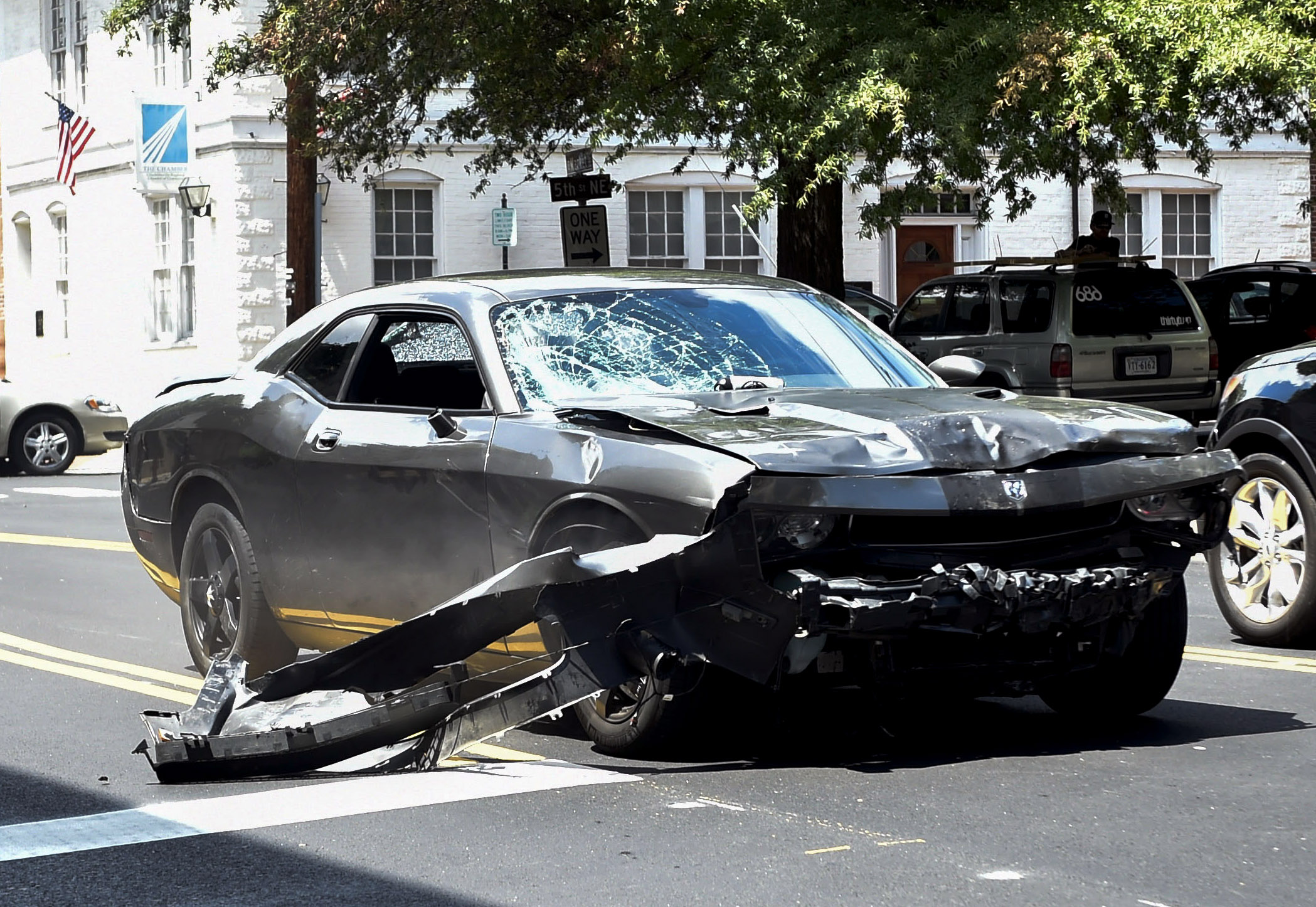 The silver Dodge Charger allegedly driven by James Alex Fields Jr. passes near the Market Street Parking Garage moments after driving into a crowd of counter-protesters on Water Street in Charlottesville, Virginia on Aug. 12, 2017. Heather Heyer, 32 years old, was killed and 19 others injured when they were struck by Fields' car. (Matthew Hatcher/Getty Images)
