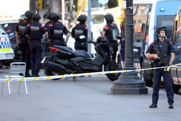 Armed policemen stand in a cordoned off area after a van ploughed into the crowd, injuring several persons on the Rambla in Barcelona on August 17, 2017. (JOSEP LAGO/AFP/Getty Images)