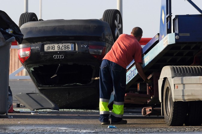 An employee starts to tow away a car involved in a terrorist attack in Cambrils, a city 120 kilometres south of Barcelona, on August 18, 2017. (LLUIS GENE/AFP/Getty Images)