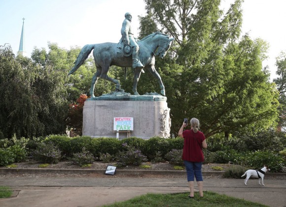 A homemade sign that says Heather Heyer Park rests at the base of the statue of Confederate Gen. Robert E. Lee that stands in the center of Emancipation Park on August 18, 2017 in Charlottesville, Virginia. (Mark Wilson/Getty Images)