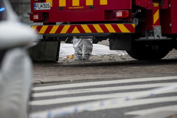 Rescue personnel have covered a stabbing victim's body at the Turku Market Square in the Finnish city of Turku where several people were stabbed on August 18, 2017. One person was killed and eight were injured in a stabbing spree in the Finnish city of Turku, a hospital director said, after police shot one suspect and warned several others could be at large. (RONI LEHTI/AFP/Getty Images)