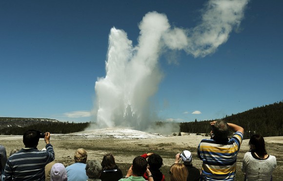 Tourists watch the 'Old Faithful' geyser which erupts on average every 90 minutes in the Yellowstone National Park, Wyoming on June 1, 2011. (MARK RALSTON/AFP/Getty Images)