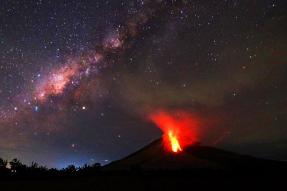 Hot lava flows down the Mount Sinabung volcano in the night in Karo, North Sumatra on July 30, 2017. (TIBTA PANGIN/AFP/Getty Images)