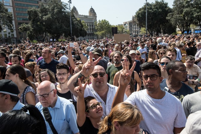 People gesture as they leave Placa de Catalunya after observing a one minute's silence for the victims of yesterday's terrorist attack, on August 18, 2017 in Barcelona, Spain. (Carl Court/Getty Images)